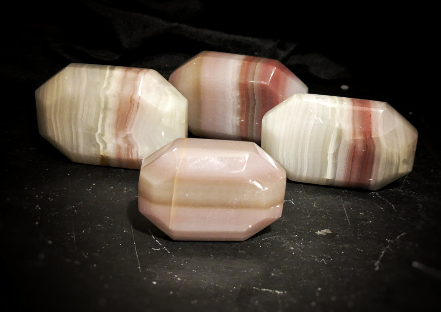Pink Banded Onyx Faceted Palmstone 1